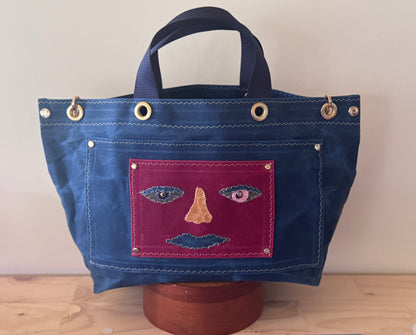 Surrealist Face Bag on Waxed Cotton