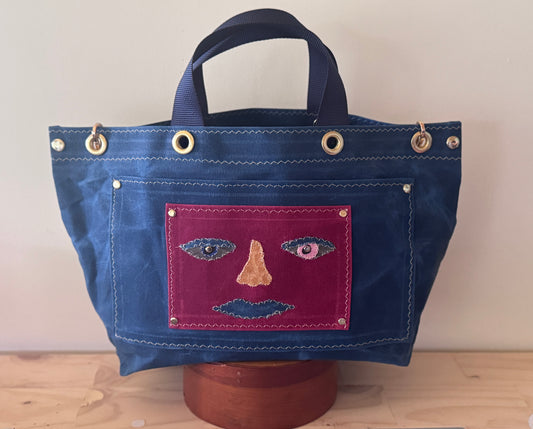 Surrealist Face Bag on Waxed Cotton